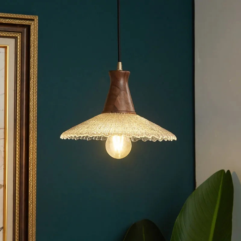 Brass and glass wooden chandelier ceiling light with clear shades in three available sizes.