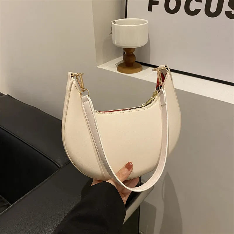 Round one-shoulder underarm bag in PU material, shown in green colour with visible sewing lines and a single strap.