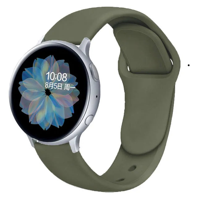 Close-up of a grey silicone smartwatch strap with a reverse buckle closure, shown detached from a watch.