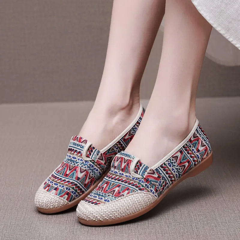Women's ethnic style flat cloth shoes in red with colour stitching and a beef tendon sole.
