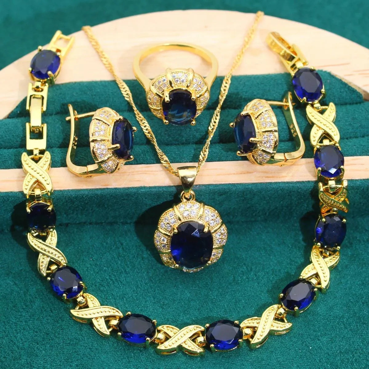 Gold plated jewellery set with colourful cubic zirconia stones, showing necklace, earrings, ring, and bracelet.