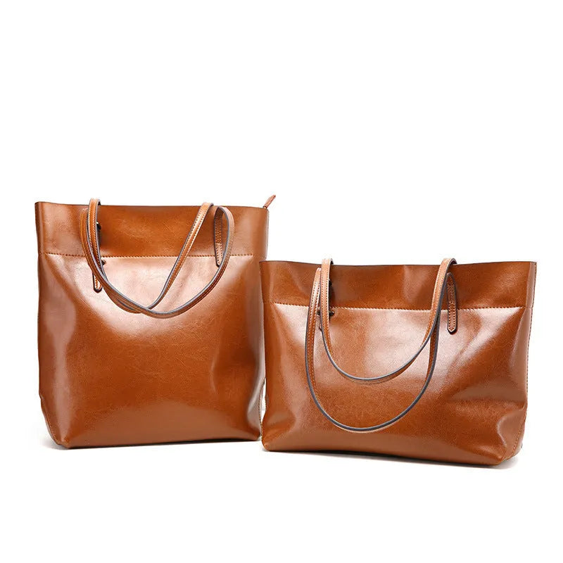 Brown waxed cowhide cross-body leather handbag showing front view with strap, measuring 30cm wide by 37cm tall.