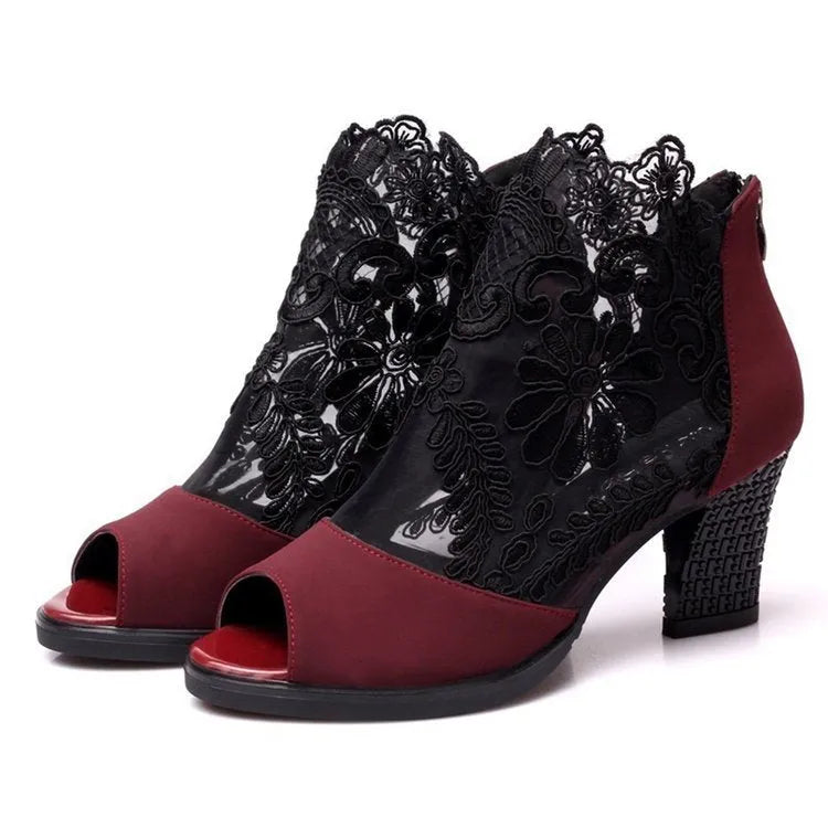 Lucyever women's black gladiator sandals with floral lace upper, square heel, and peep toe on a foot.