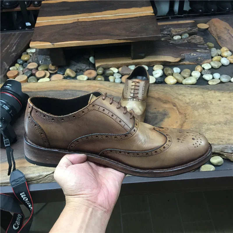 Light brown men's vintage casual leather shoes with hand-carved distressed detailing and a round toe.