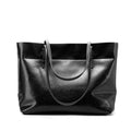 Brown waxed cowhide cross-body leather handbag showing front view with strap, measuring 30cm wide by 37cm tall.