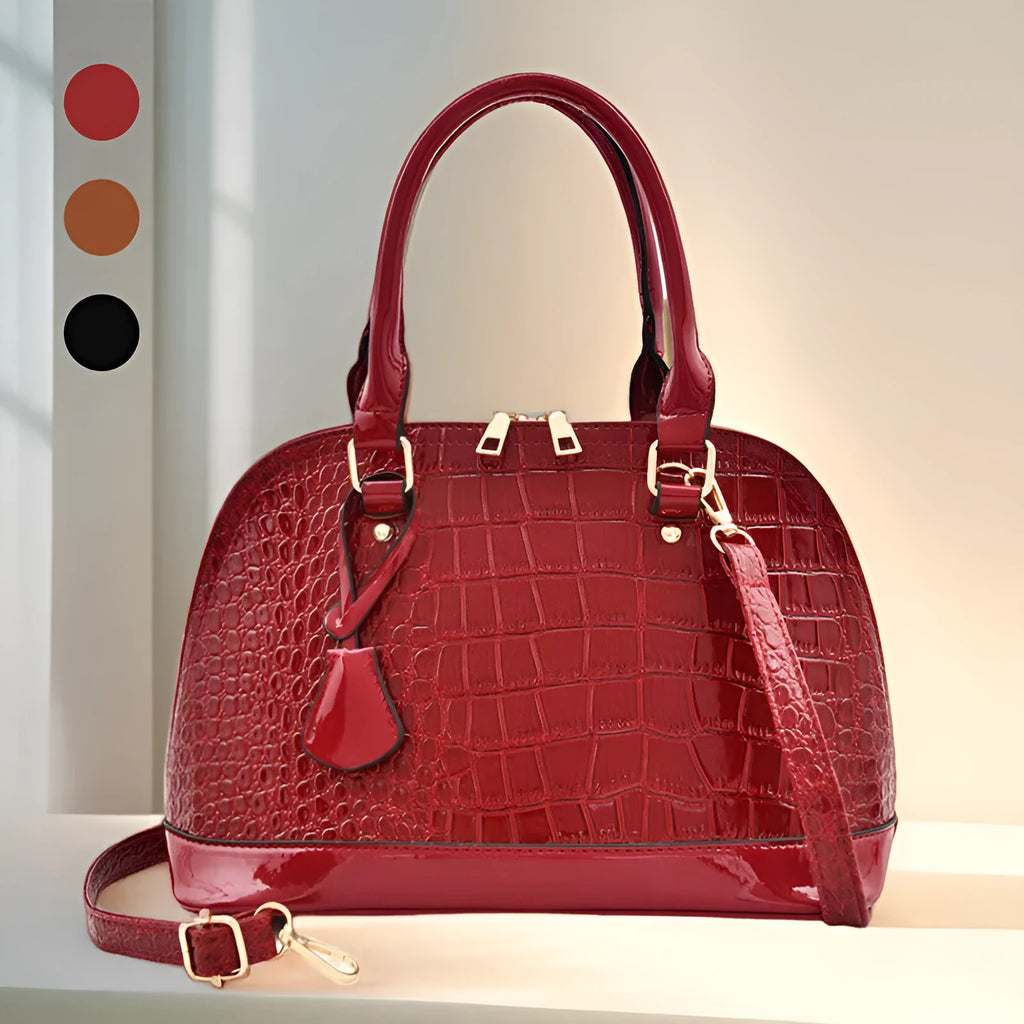 Shiny black structured shell shape crossbody shoulder bag showing large capacity and interior lining.