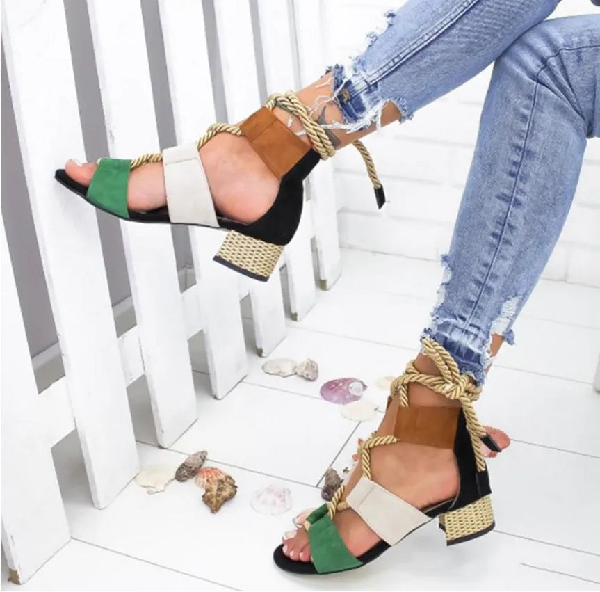 Women's beige suede sandals with a thick middle heel, fish mouth toe, and front ankle straps.