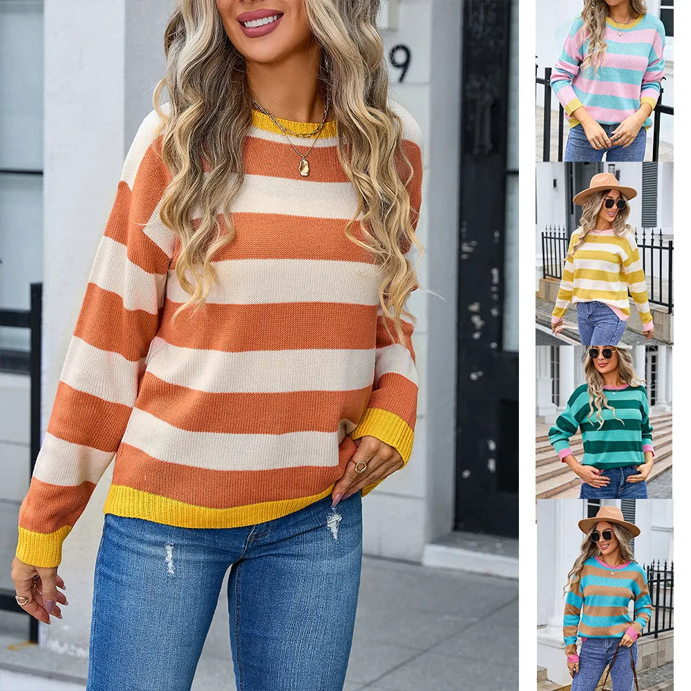 Women's loose blue acrylic sweater with long sleeves and a striped pattern on a hanger.