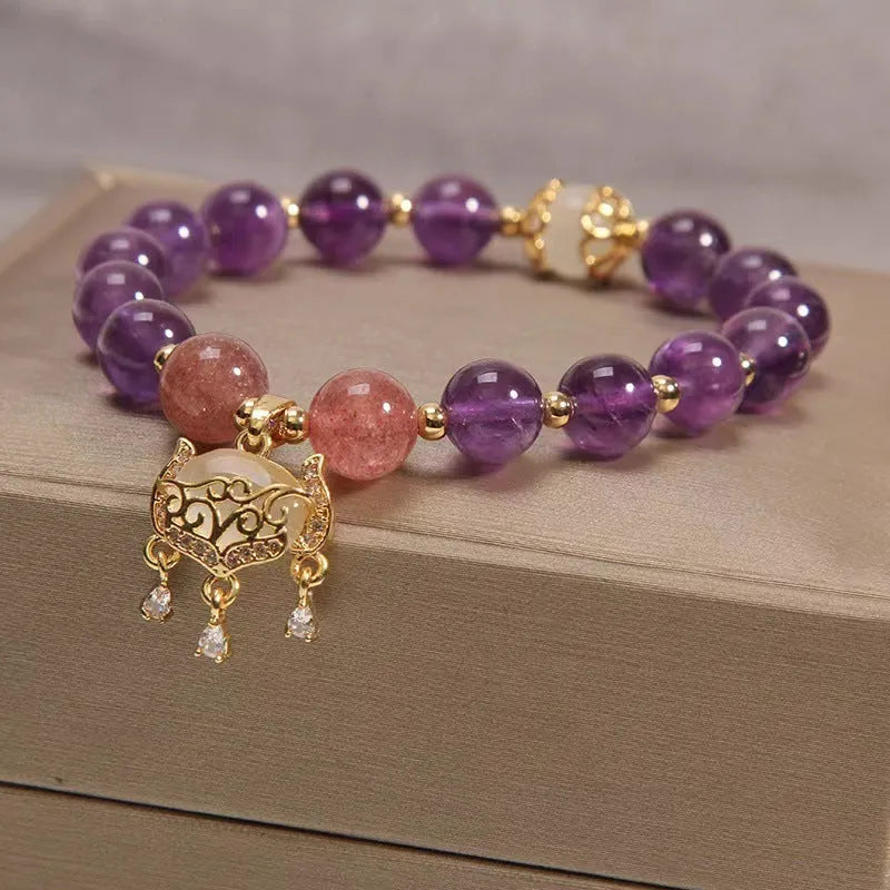 Handmade copper women's bracelet with a drop-shaped longevity lock charm and natural amethyst stones.