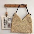 Women's beige straw hollow shoulder handbag in heart shape with woven texture and medium hardness