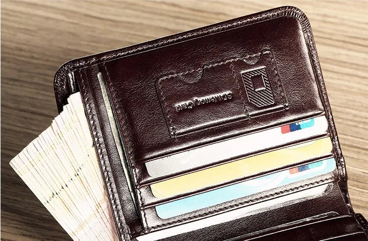 Men's black genuine leather bifold wallet open, showing eight card slots and a zipped coin compartment.