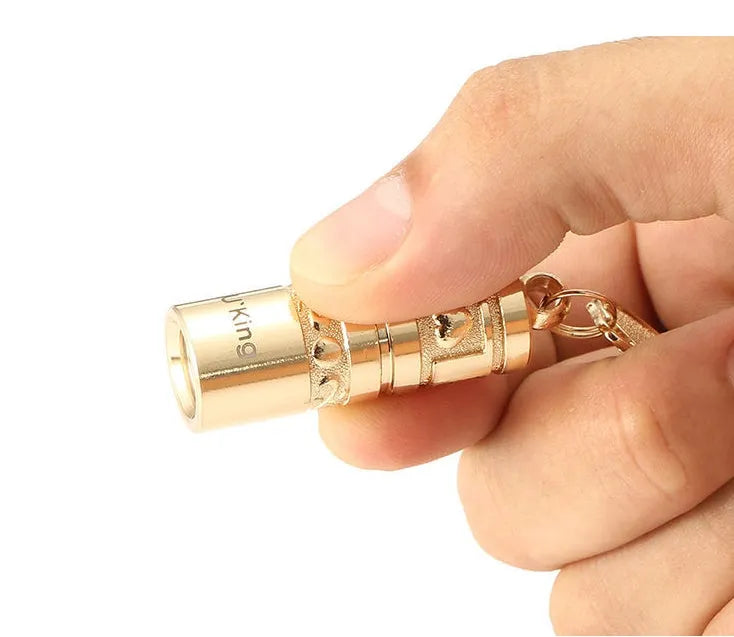 Gold zinc alloy waterproof LED flashlight attached to a keyring.