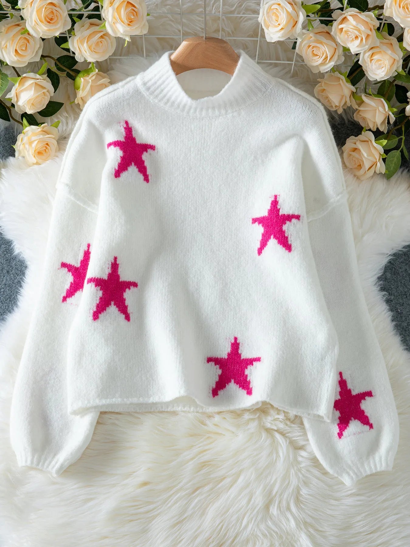 White women's loose turtleneck pullover with a thick imitation velvet texture and a five-pointed star pattern on the front.
