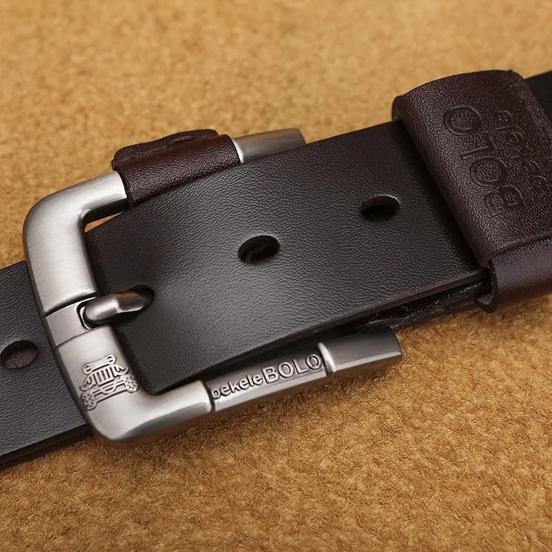 Men's cowhide leather belt with round alloy pin buckle, black colour, on a flat surface