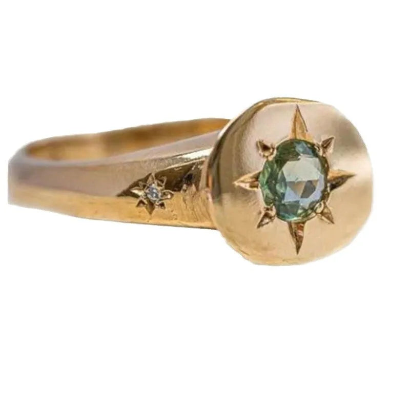 Golden oval ring with adjustable opening and a micro-inlaid star-shaped zircon stone on a zinc alloy band.
