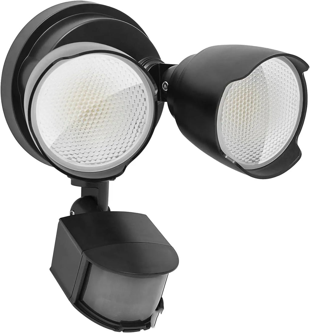 White outdoor LED security flood light with PIR motion sensor mounted on a wall beside a garage door.