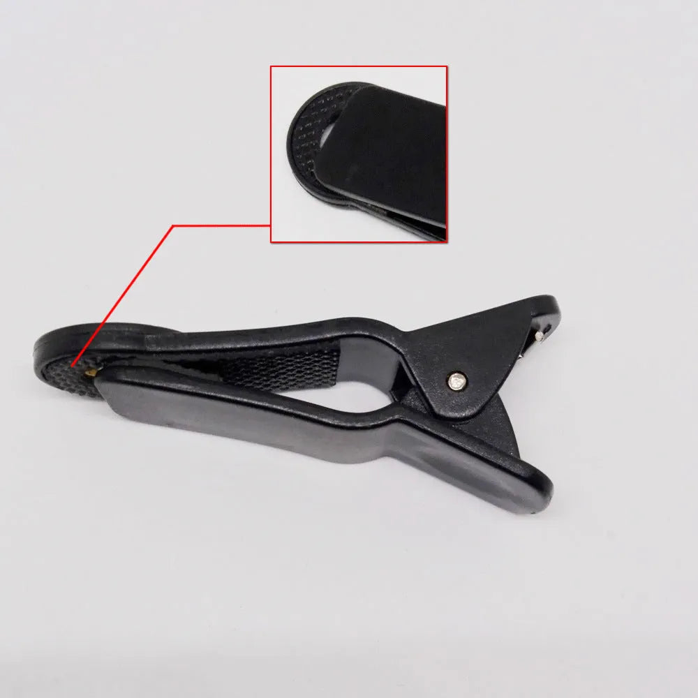 Silver and black telescopic phone lens with a separate metal clip for attachment to a smartphone.