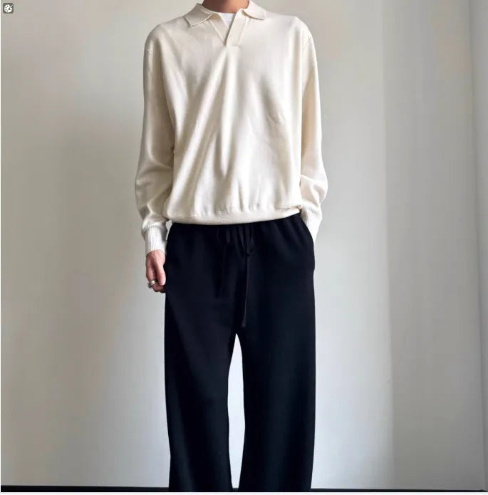 Man wearing a milky white pure wool polo sweater with a lapel collar and loose fit.
