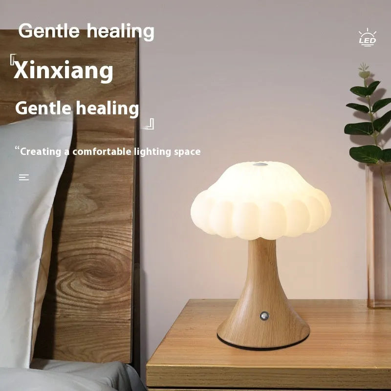 Decorative mushroom-shaped touch lamp in wood grain colour on a tabletop.
