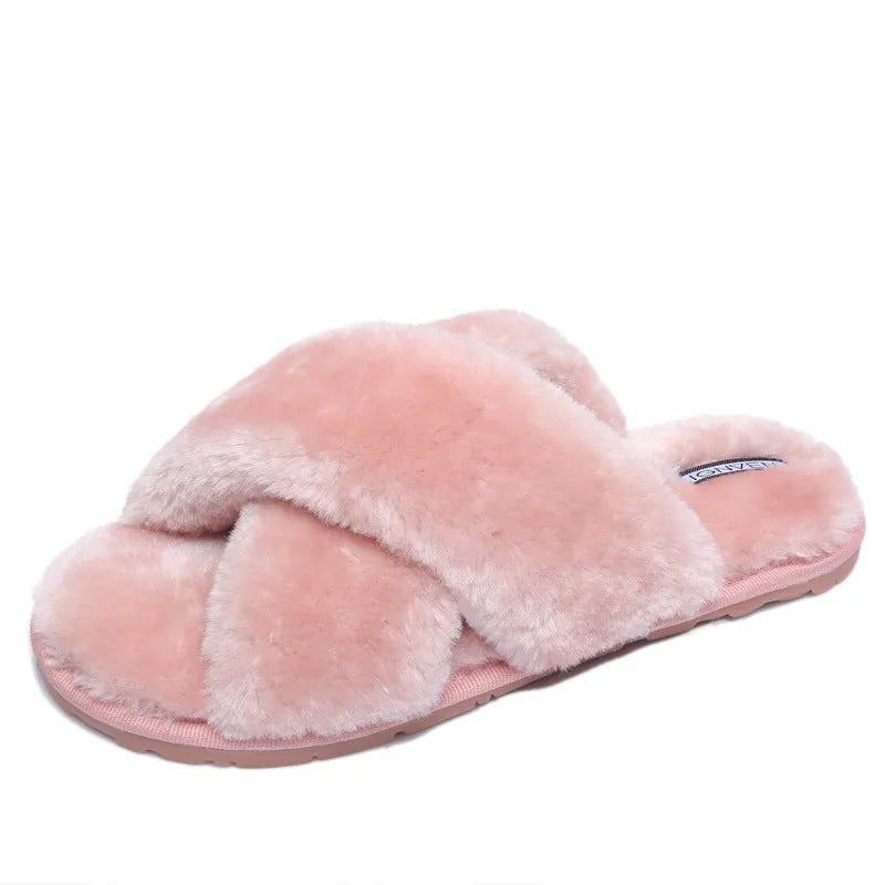 Women's black cross open-toe fur slippers with a textured sole on a light background.