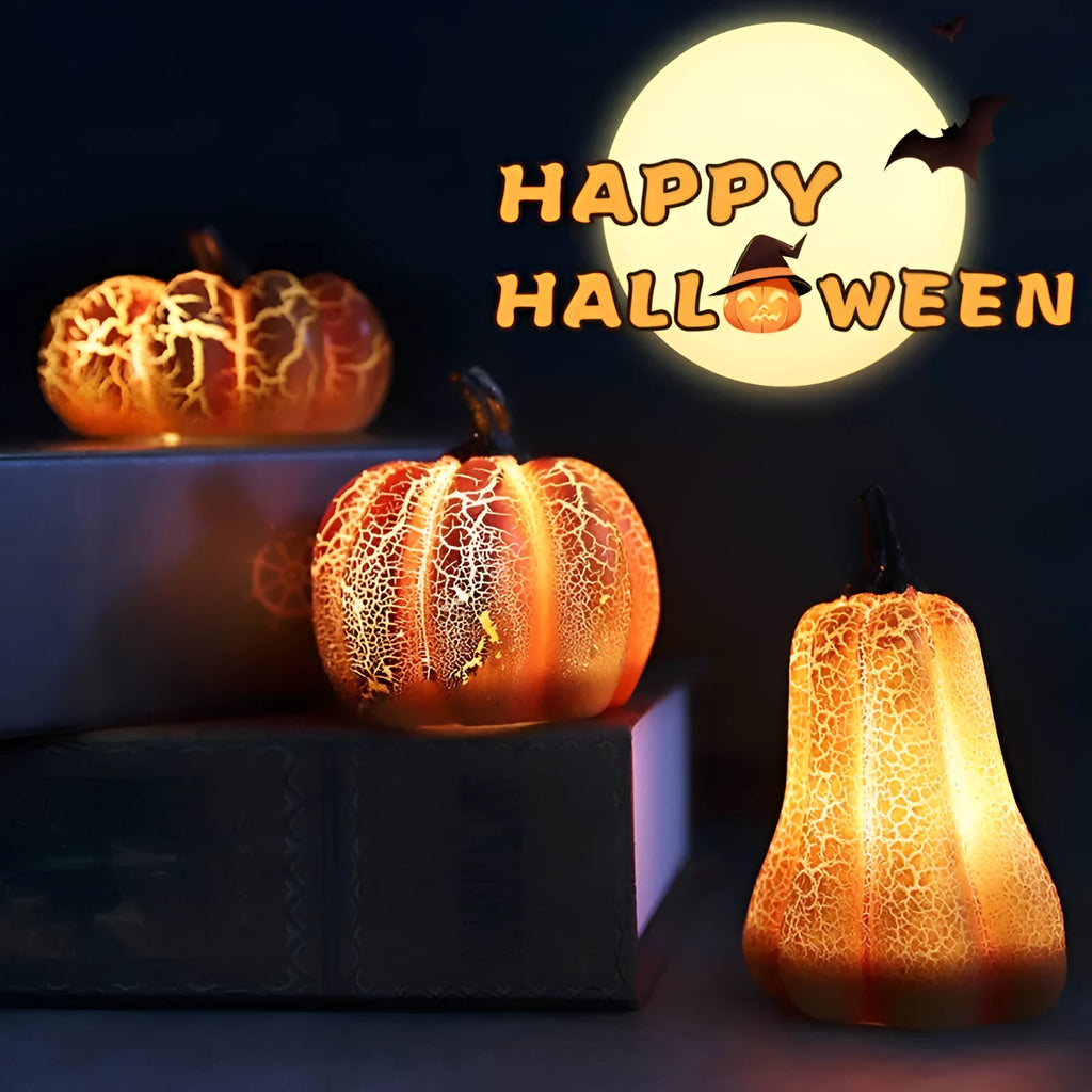Three LED pumpkin lanterns in different sizes with realistic surface cracks and candle-like glow