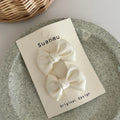 Fabric bowknot children's hair clip in cream colour with 6cm bow size on side clip