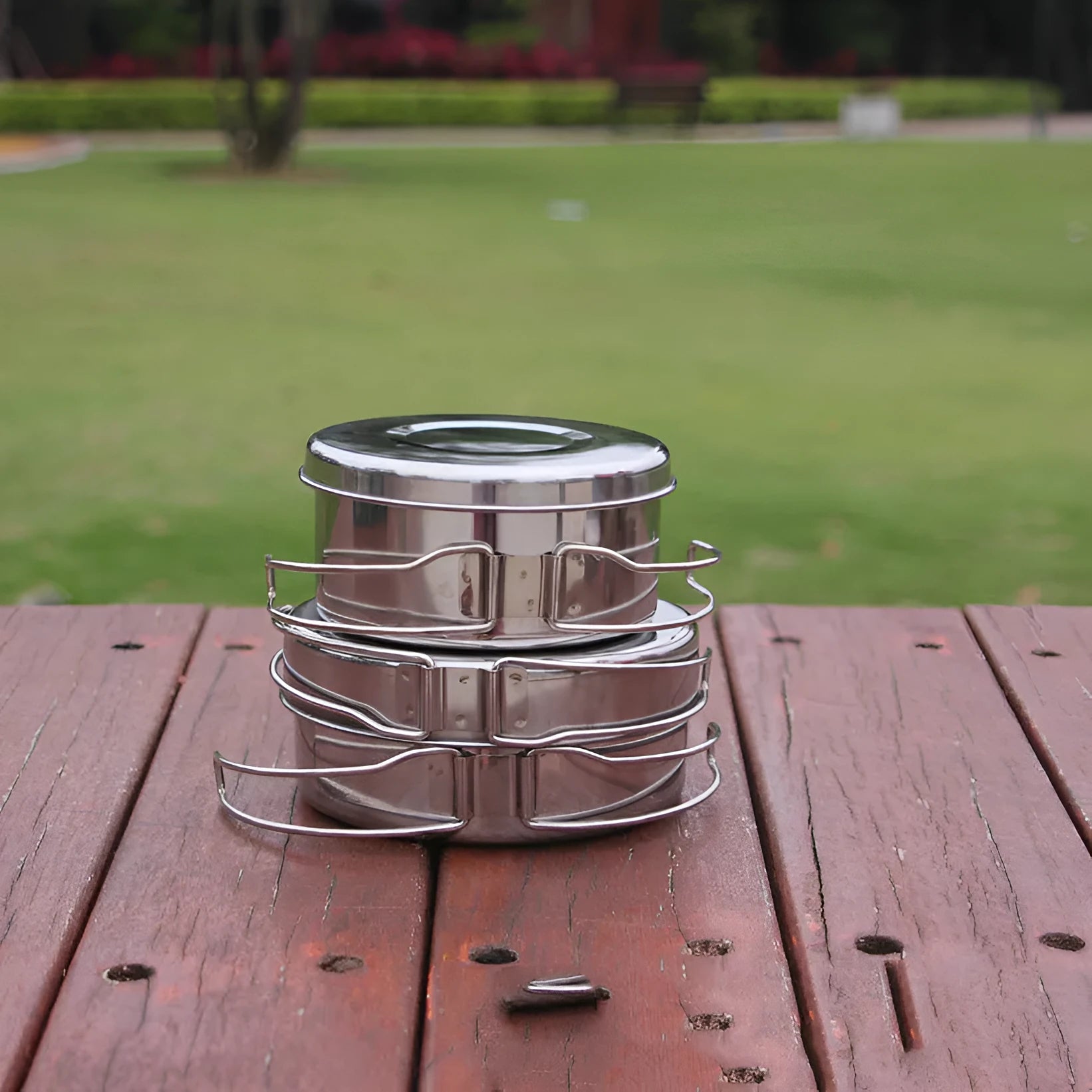 Silver stainless steel camping cookware set with 4 round pots for outdoor cooking
