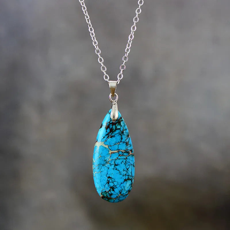 Emperor Stone jade pendant necklace on a gold chain, showing hand-carved detail and a lobster clasp.