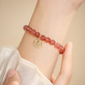 Handmade strawberry quartz blessing card bracelet with glass construction and adjustable universal wrist size