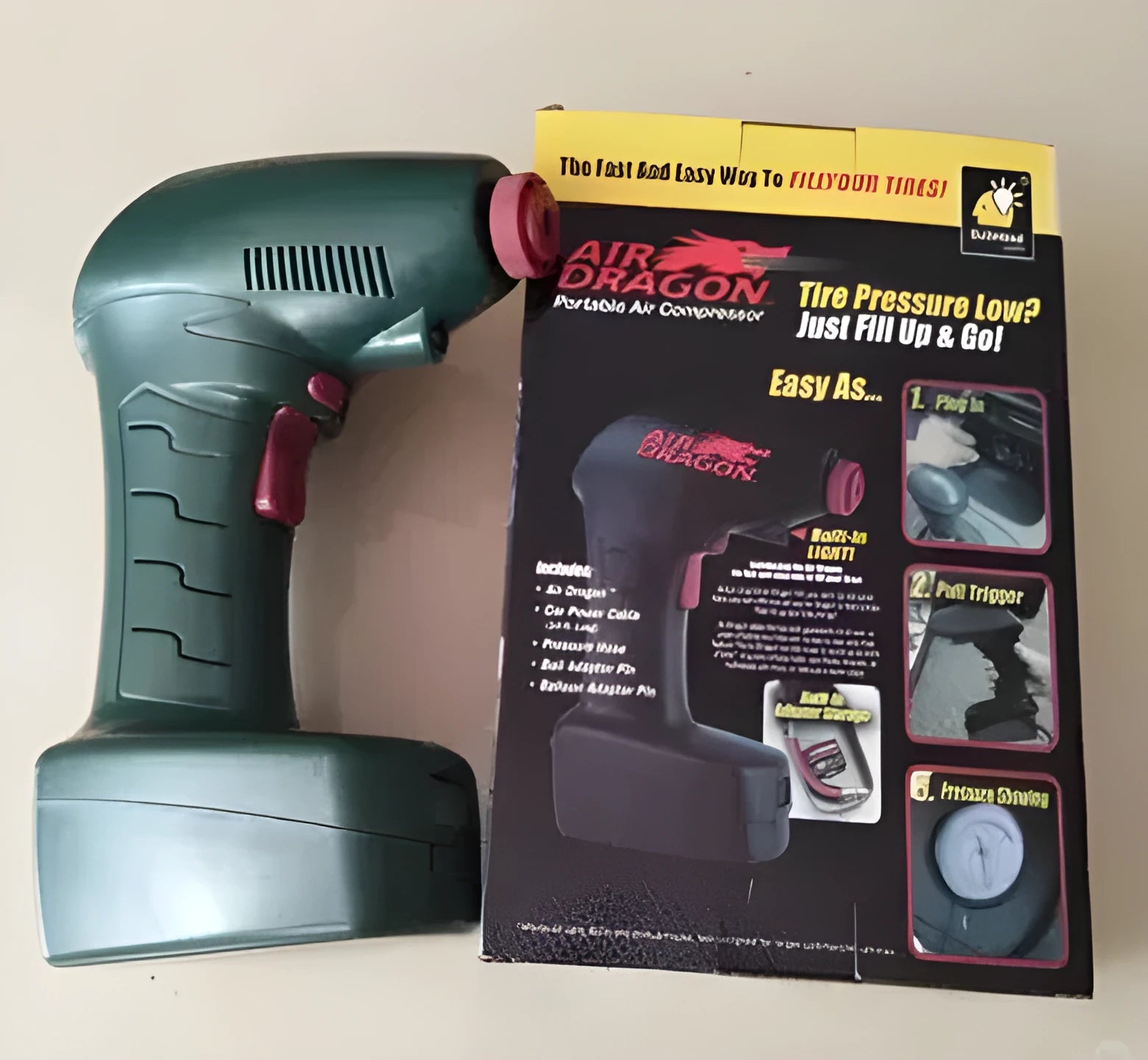 Compact black 12V portable car tyre inflator with digital display screen and LED light.
