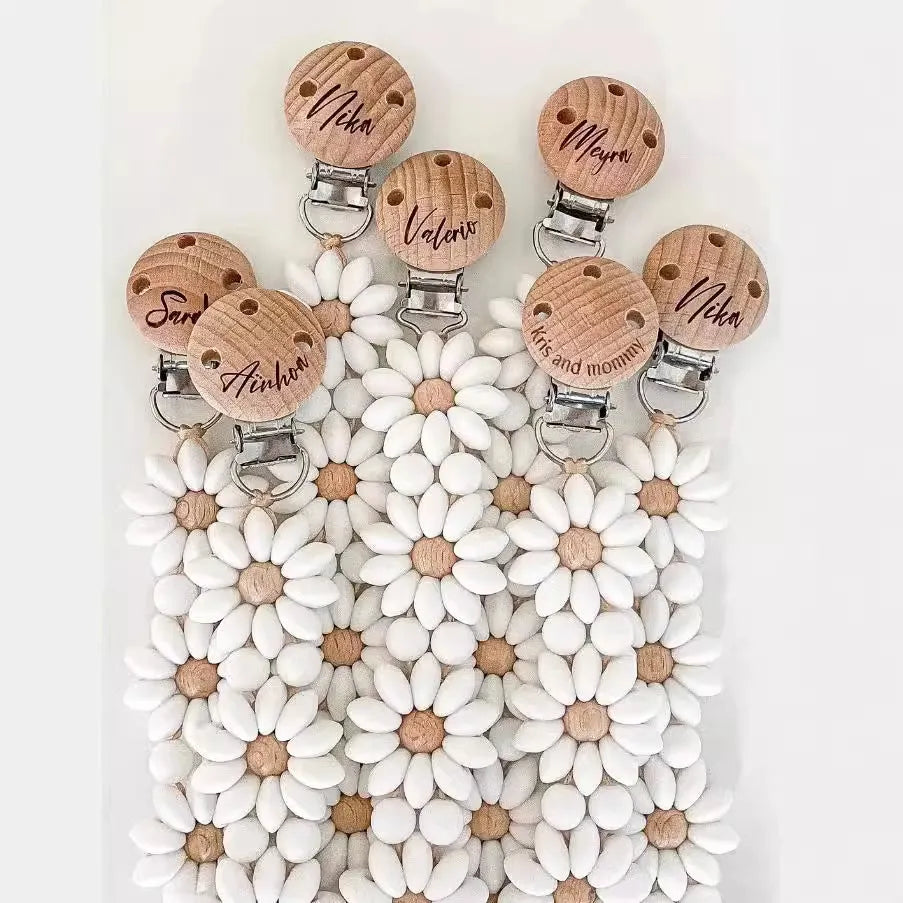 Baby flower silicone pacifier clip in pink on white background with custom name option
