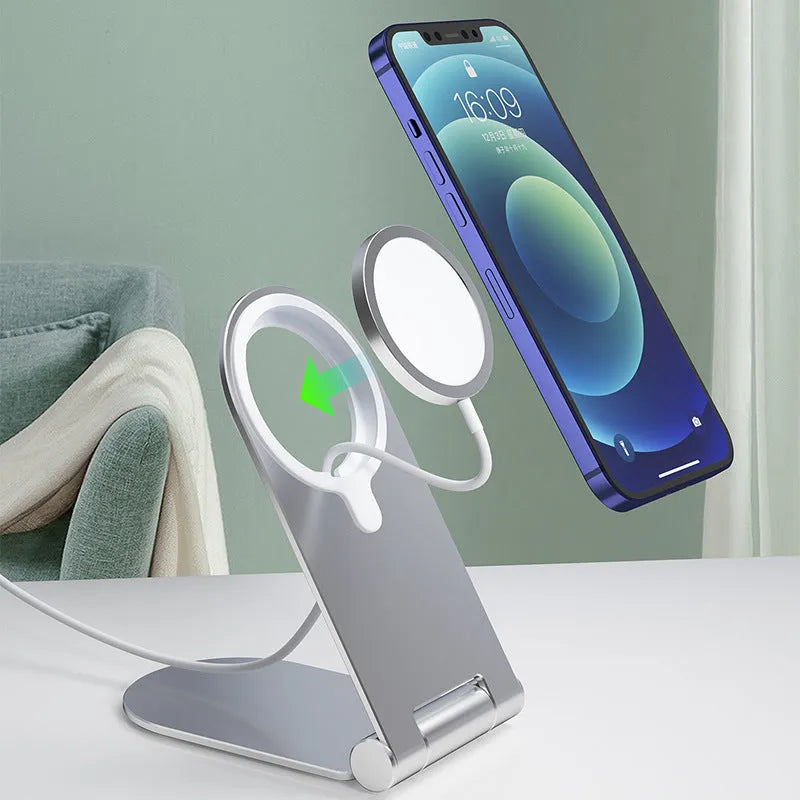 Silver vertical adjustable magnetic phone mounting bracket for iPhone12 on a desk.
