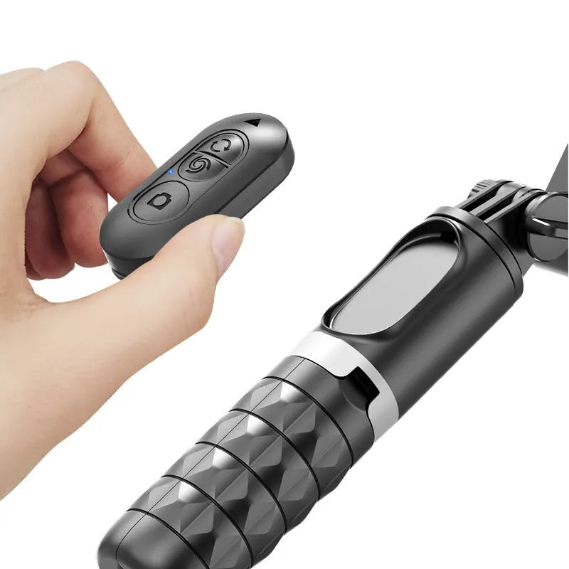 Black anti-shake phone stand with retractable selfie stick and desktop pan tilt on table