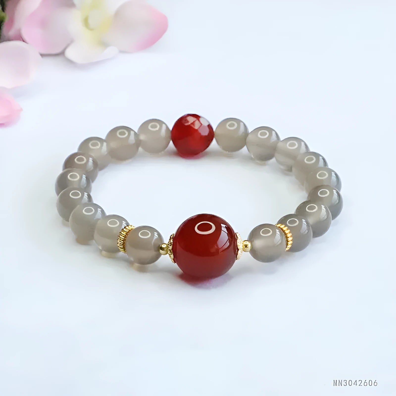 Smoky purple and red agate bracelet with 8mm geometric beads on a white background.