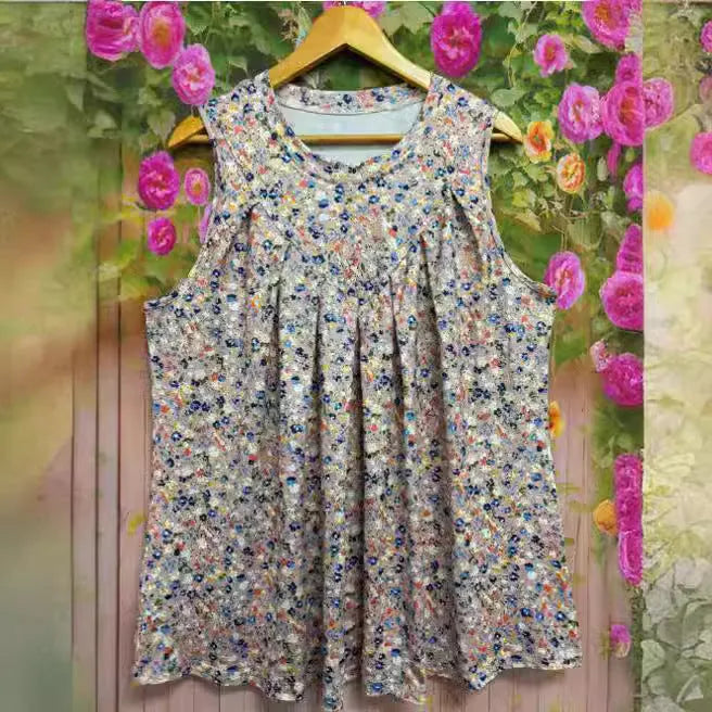 Black plus size sleeveless vest with white floral print, showing loose fit and round neckline.
