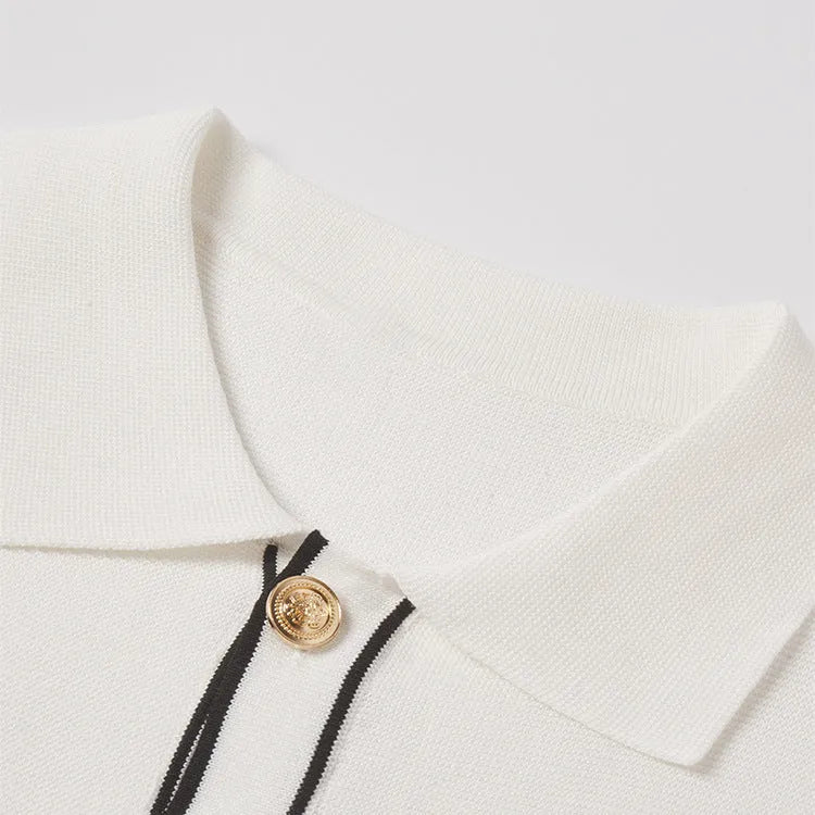 White short sleeve cardigan with dark contrast lapels, buttoned front, and a soft drape fabric.