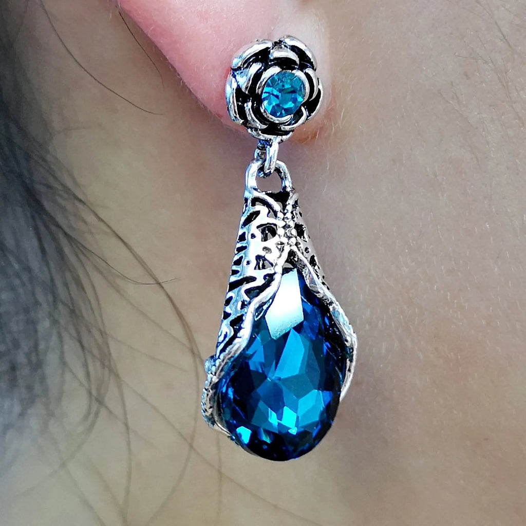 Retro peacock blue crystal water drop drop earrings on a light background