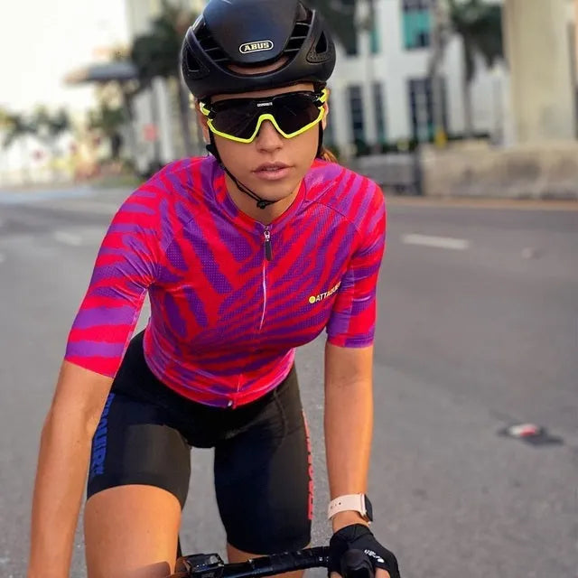 Attaquer women's Kaleidoscope TEAM print cycling jersey and pants set on a model.