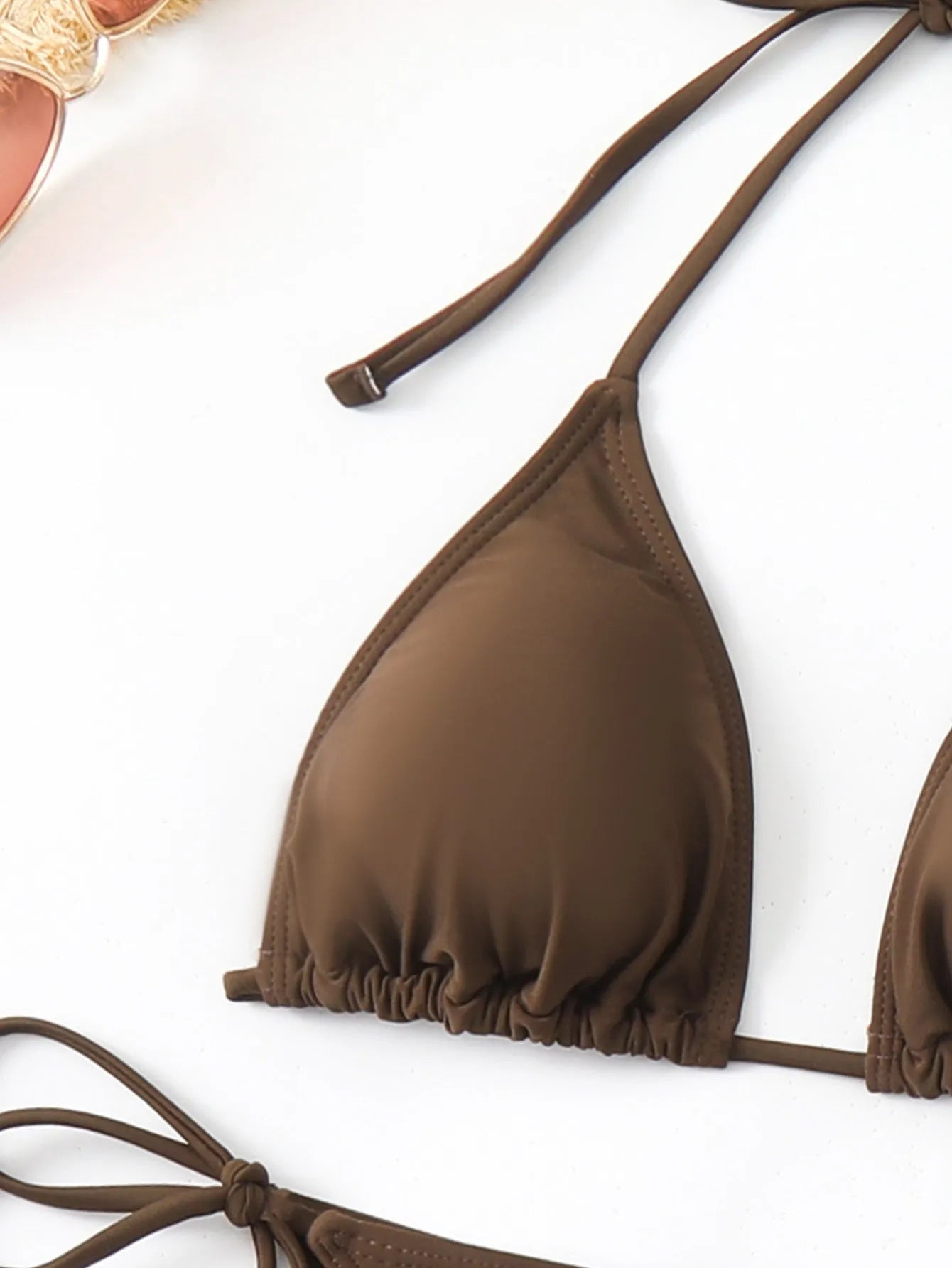 Brown solid colour women's three-piece bikini set with bra, shorts, and blouse on a neutral background.