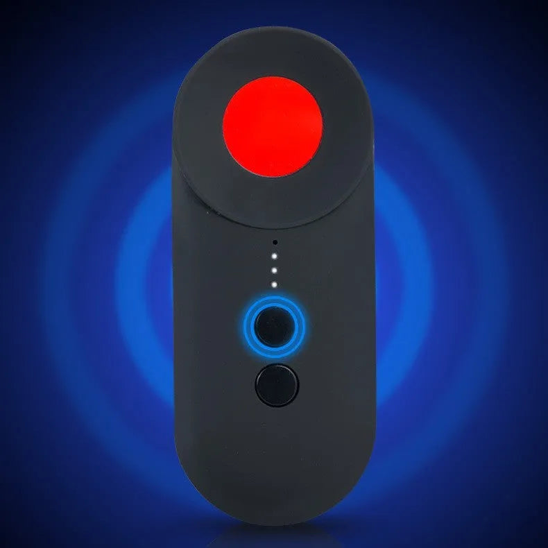 Black portable anti-car GPS and wifi signal detector with a USB cable on a table.