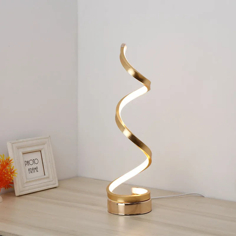 Minimalist black LED table lamp with aluminium shade on wooden desk