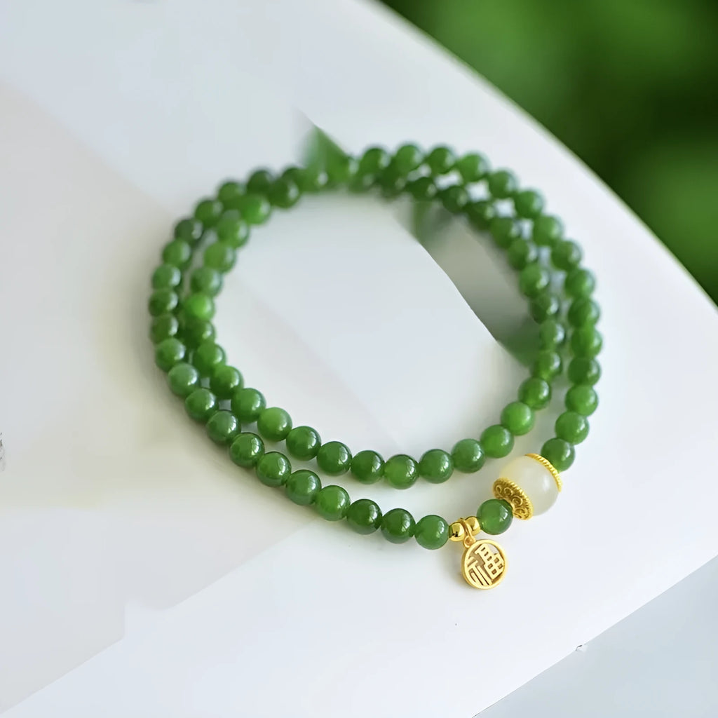 Natural Hetian jade double circle bracelet with 6mm beads and a carved fu character charm.