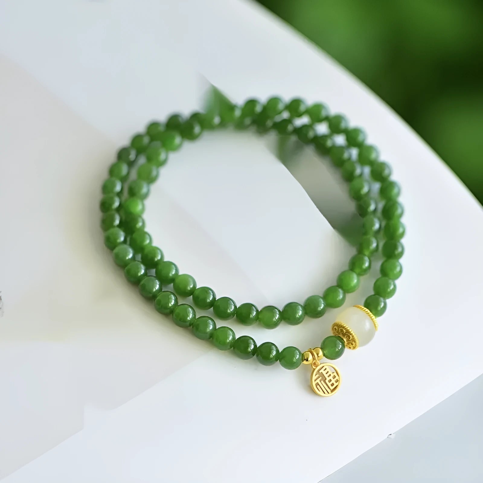 Natural Hetian jade double circle bracelet with 6mm beads and a carved fu character charm.
