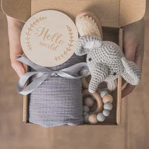 Baby teething gift set with bamboo gauze blanket, wooden chewing ring, woven bell, and developmental toys