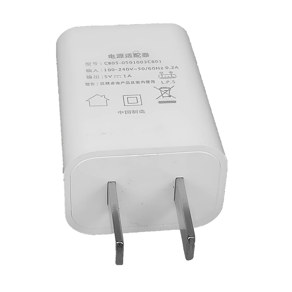 Thin white USB wall charger with CE and FCC marks on a plain background.