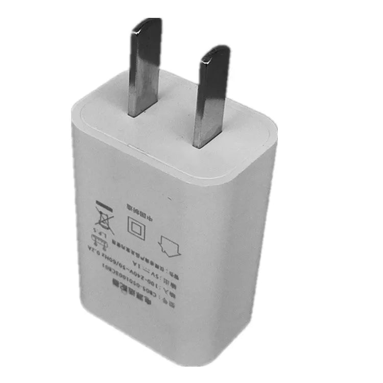 Thin white USB wall charger with CE and FCC marks on a plain background.