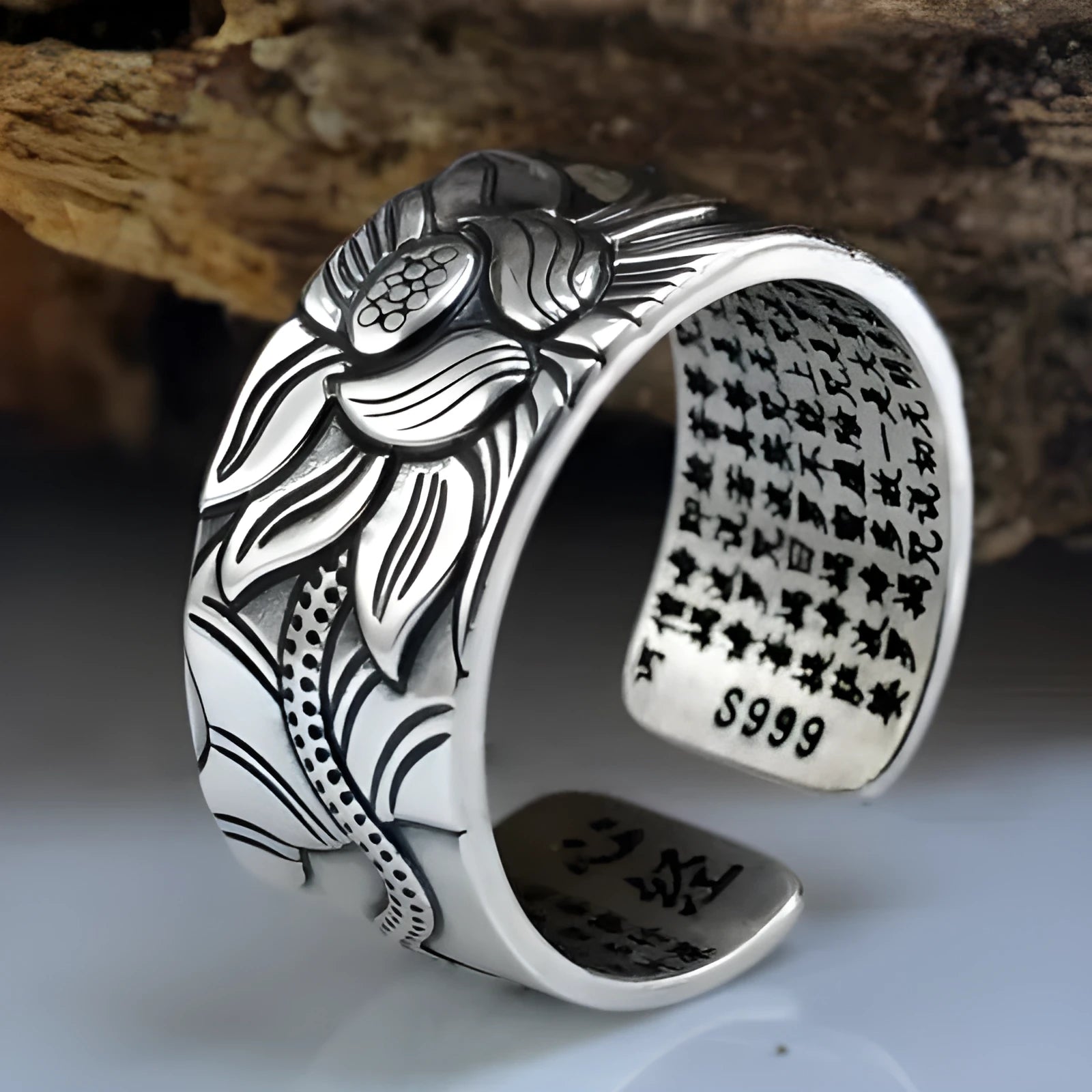 Thai silver black Lotus Heart Sutra ring with retro geometric pattern and matte oiling finish on grey background