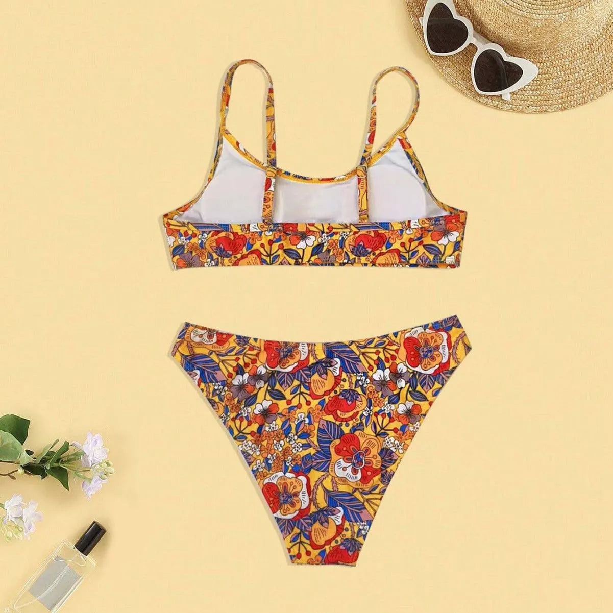 Plus size floral print strapped bikini swimsuit top and briefs on a white background.