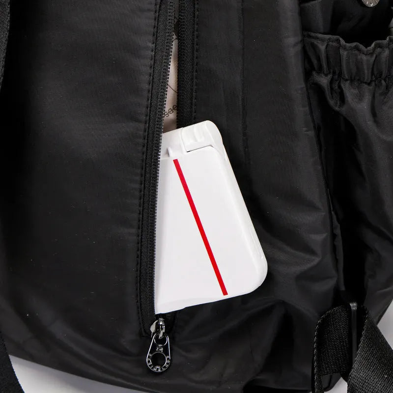 Large black nylon outdoor backpack with a front sandwich pocket, shown next to a khaki version.