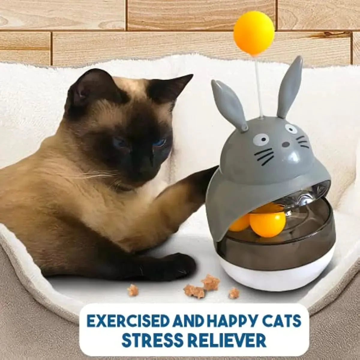 Interactive cat feeder toy with sounding bell and car tower shape in brown, grey, pink, and white